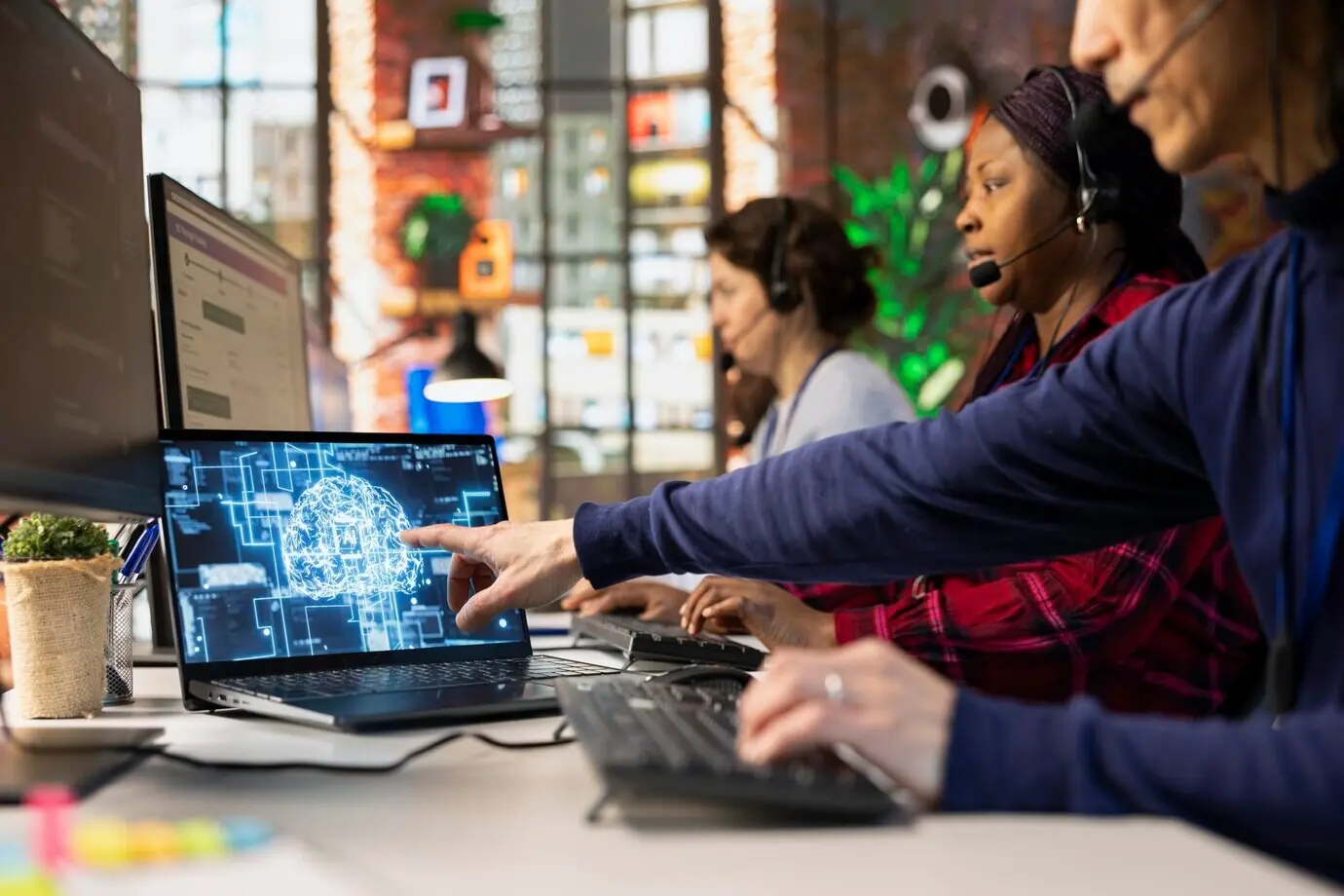 Call center agent using an AI chatbot at an office desk