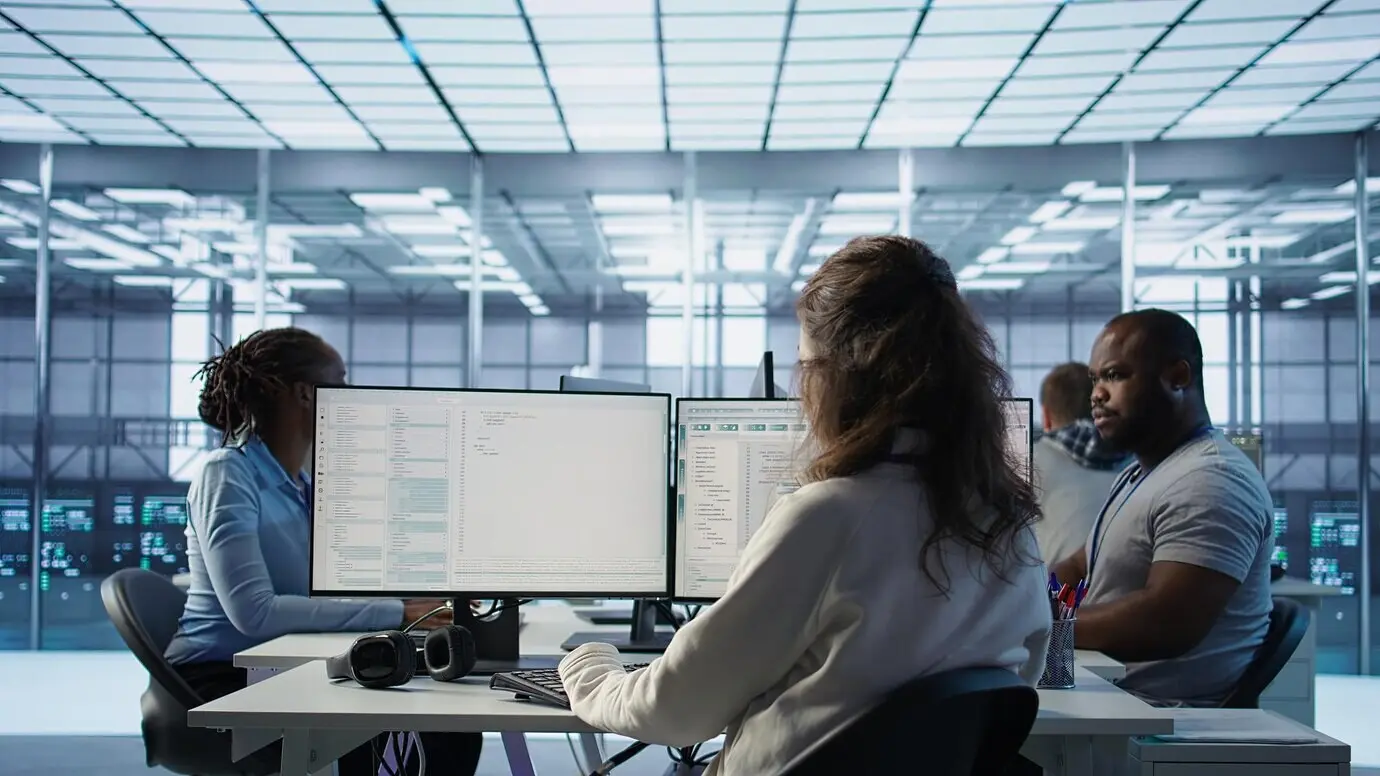 Admin entering the server hub, seated at a computer desk.